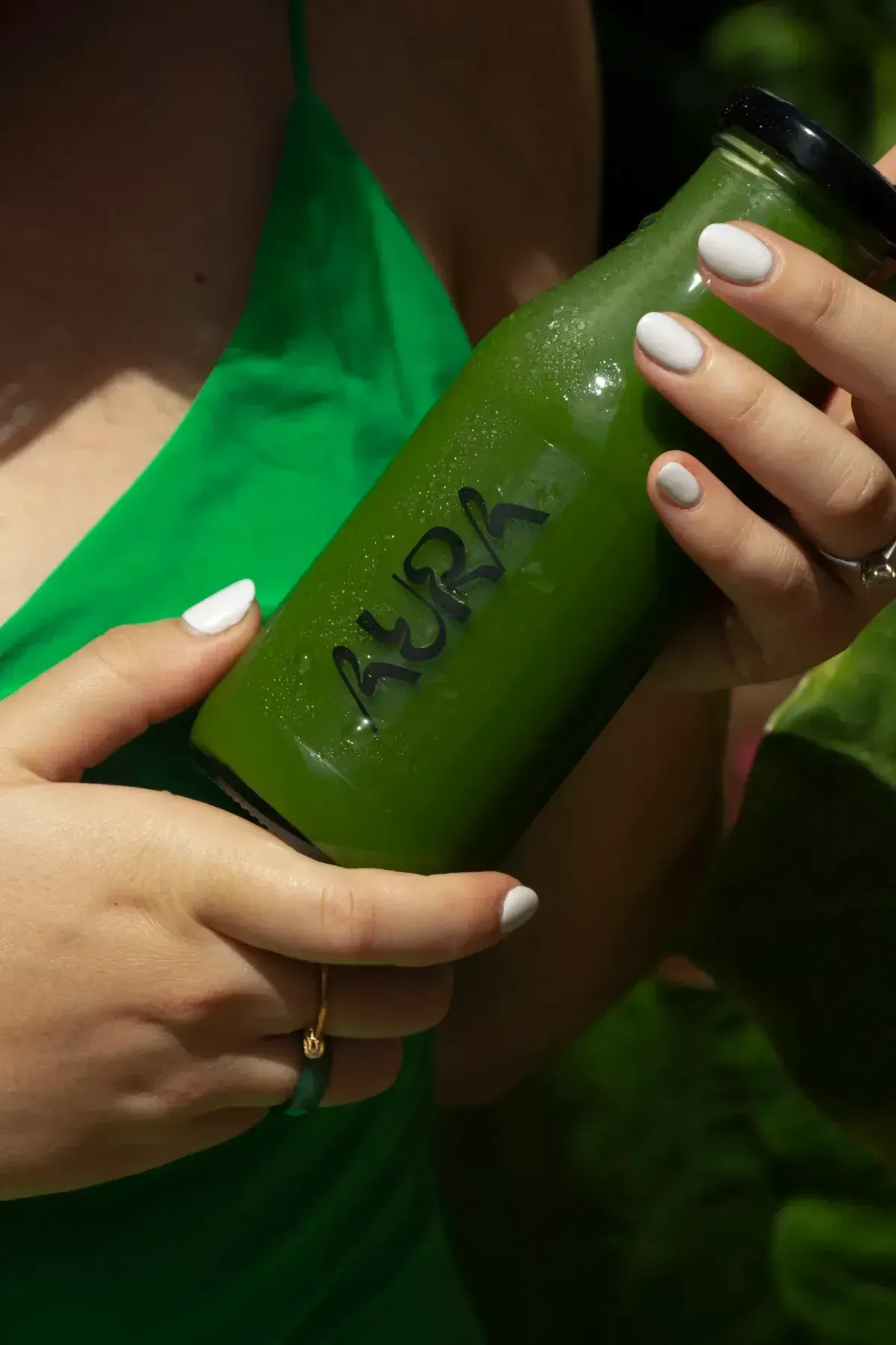 RAW cold-pressed green juice in a returnable Aura glass bottle
